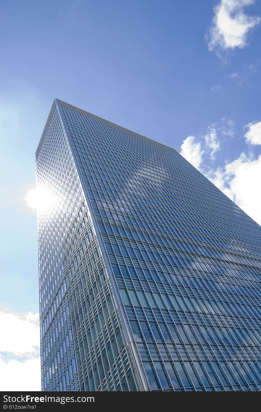 Glass skyscraper on blue sky