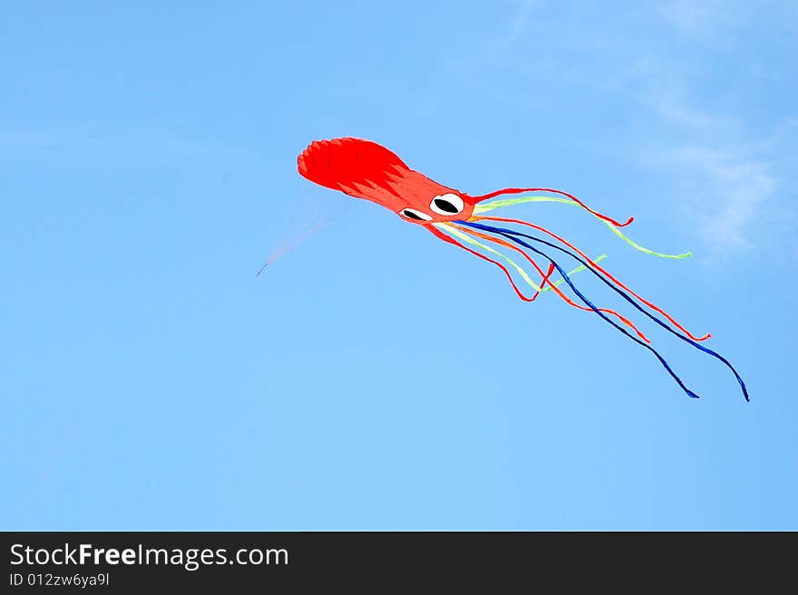 A colourful cuttlefish kite on a blue sky