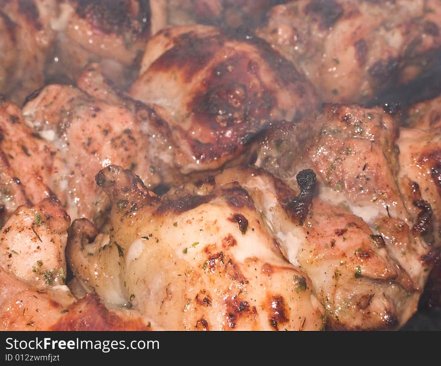 Shish kebab preparation on a brazier. Outdoor picnic. Close up.