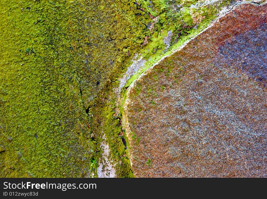 Colored (prevaling green and brown) rough stone surface with lichen