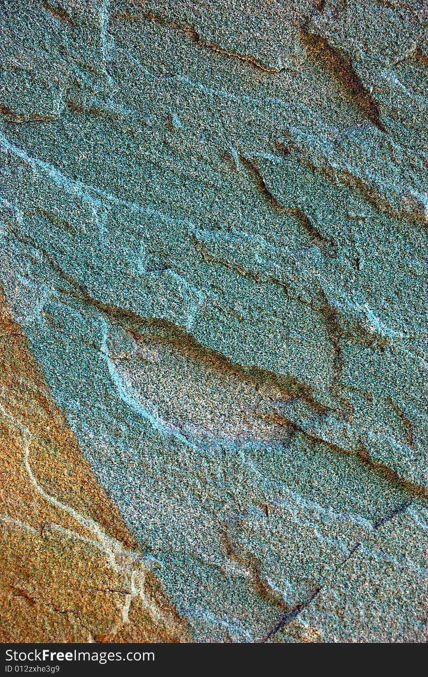 Colored (prevaling blue and brown) rough stone surface