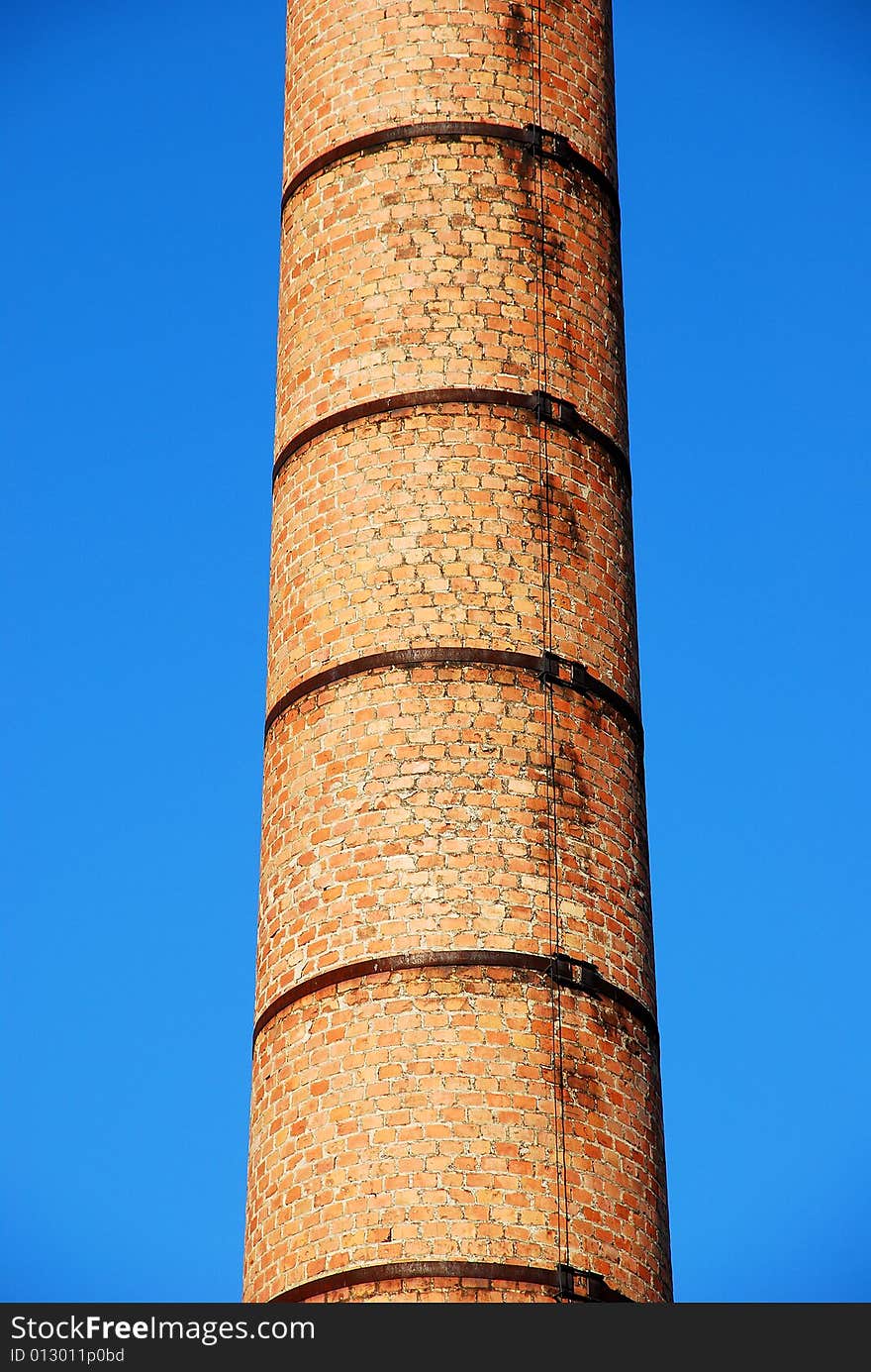 Old brick tower detail and clear blue sky. Old brick tower detail and clear blue sky