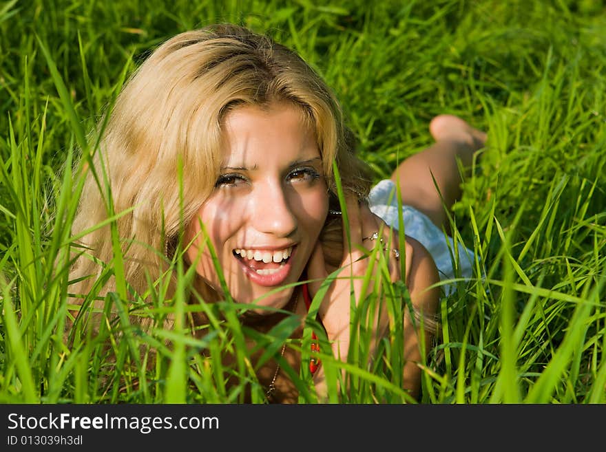 Beautiful girl lays on a green grass. Beautiful girl lays on a green grass