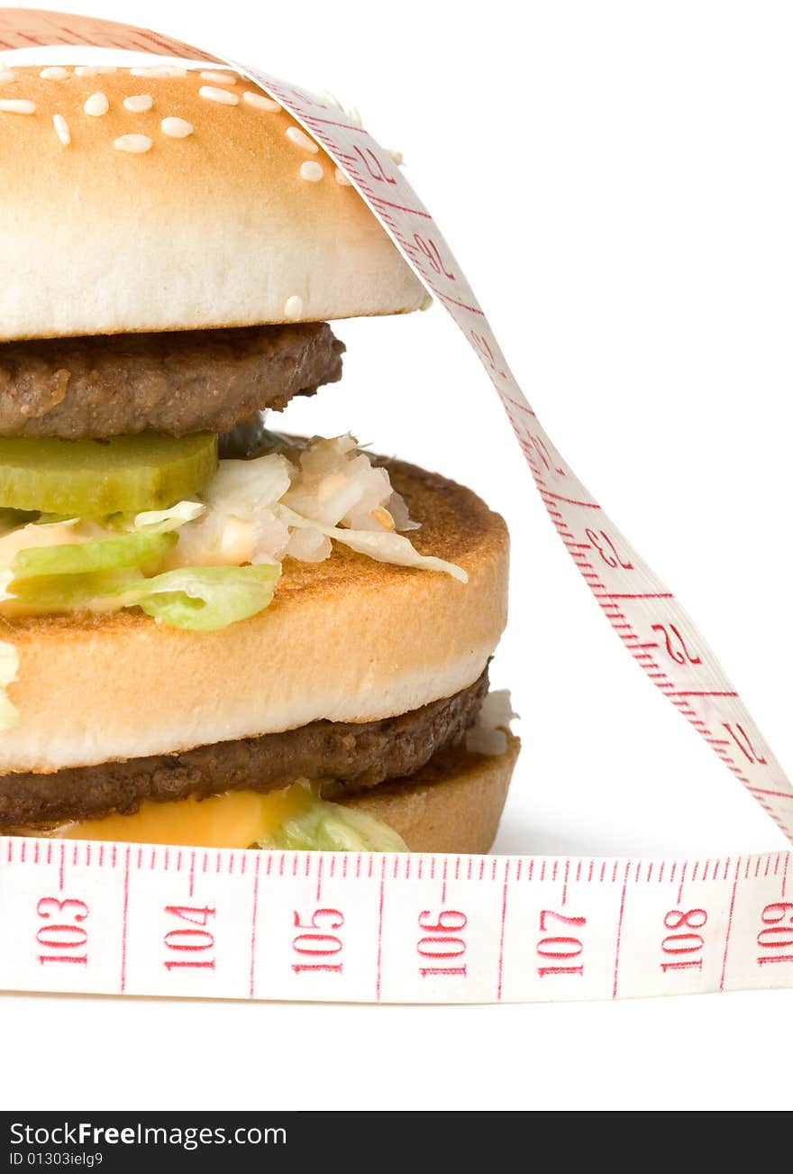 Bread with fried meat, cheese, onion, lettuce and measuring tape isolated on a  white background. Bread with fried meat, cheese, onion, lettuce and measuring tape isolated on a  white background.