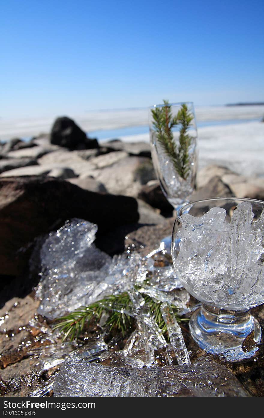 Glasses with ice on the edge of a frozen lake