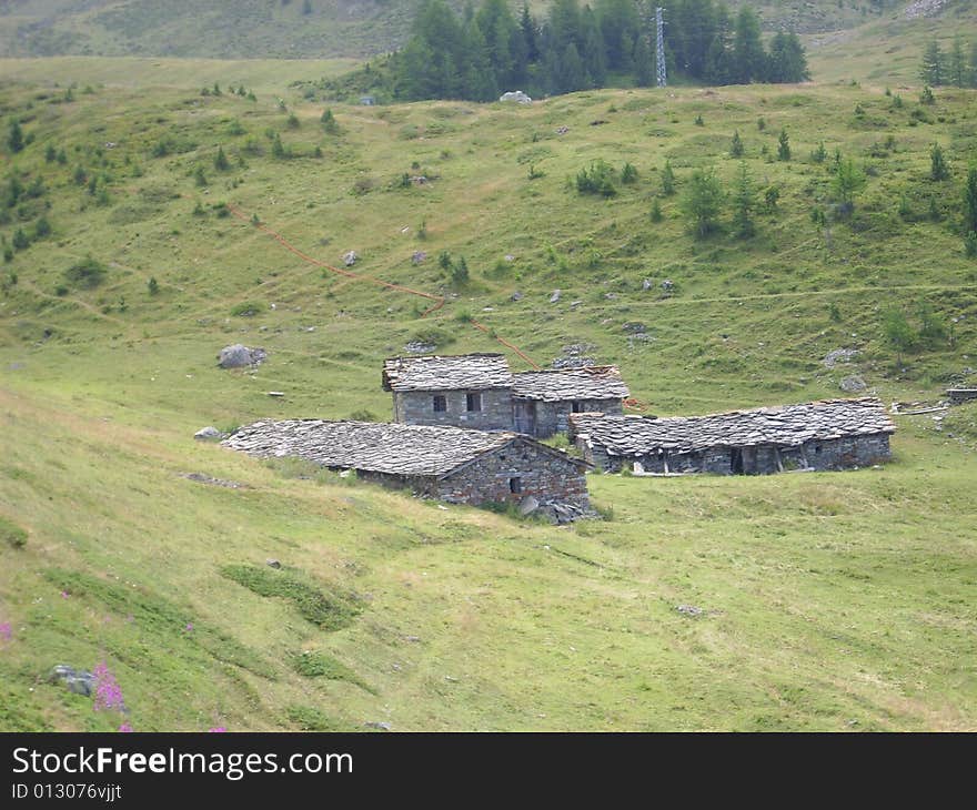 Old mountain farms and houses along a trekking road in Pila, Valle d'Aosta, Italy, Europe. Old mountain farms and houses along a trekking road in Pila, Valle d'Aosta, Italy, Europe