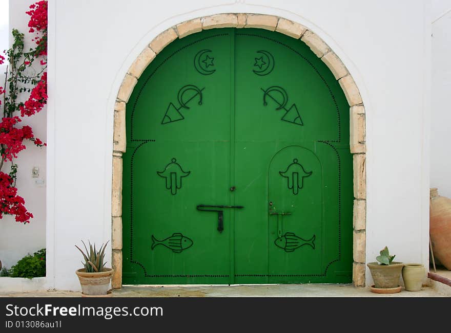 Green gate with arabic symbols.