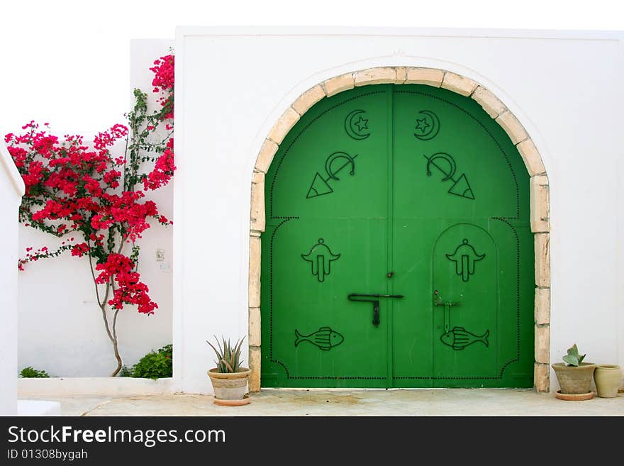 Green gate with arabic symbols.