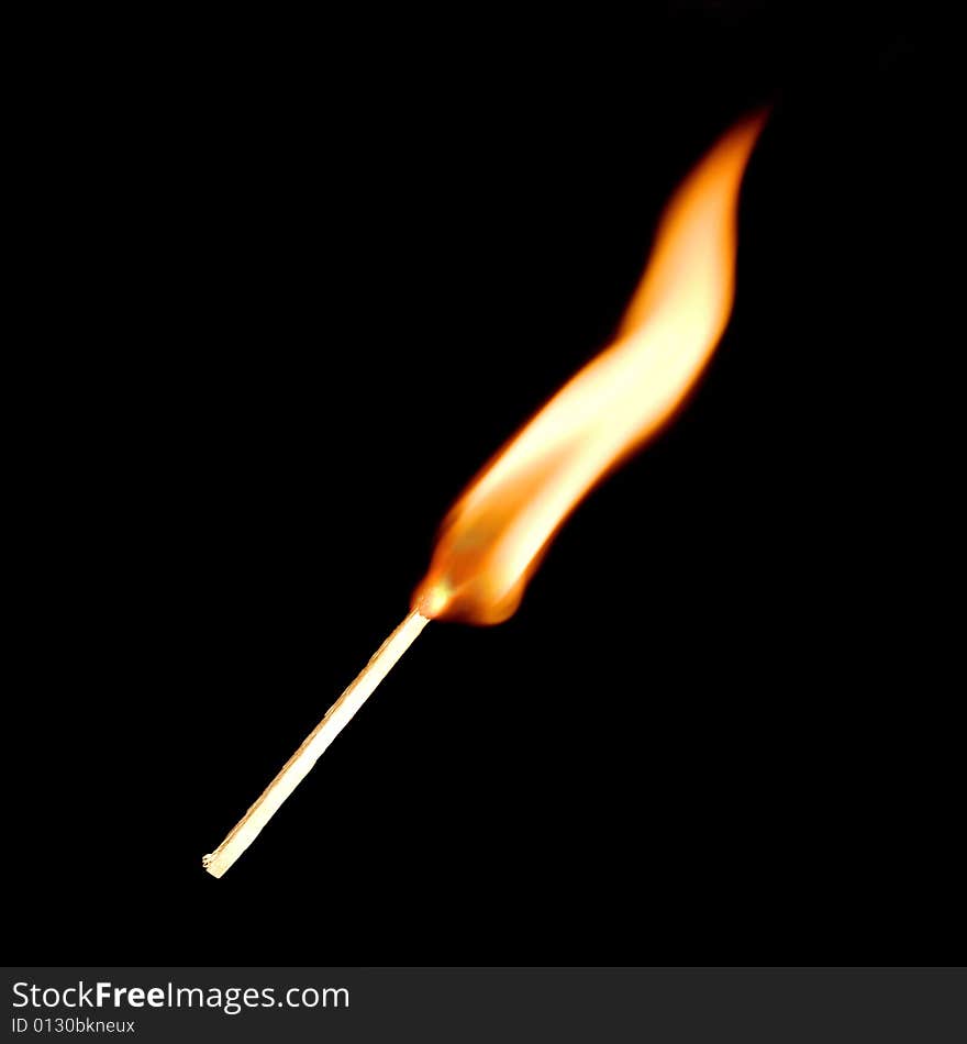 Match fire on black background