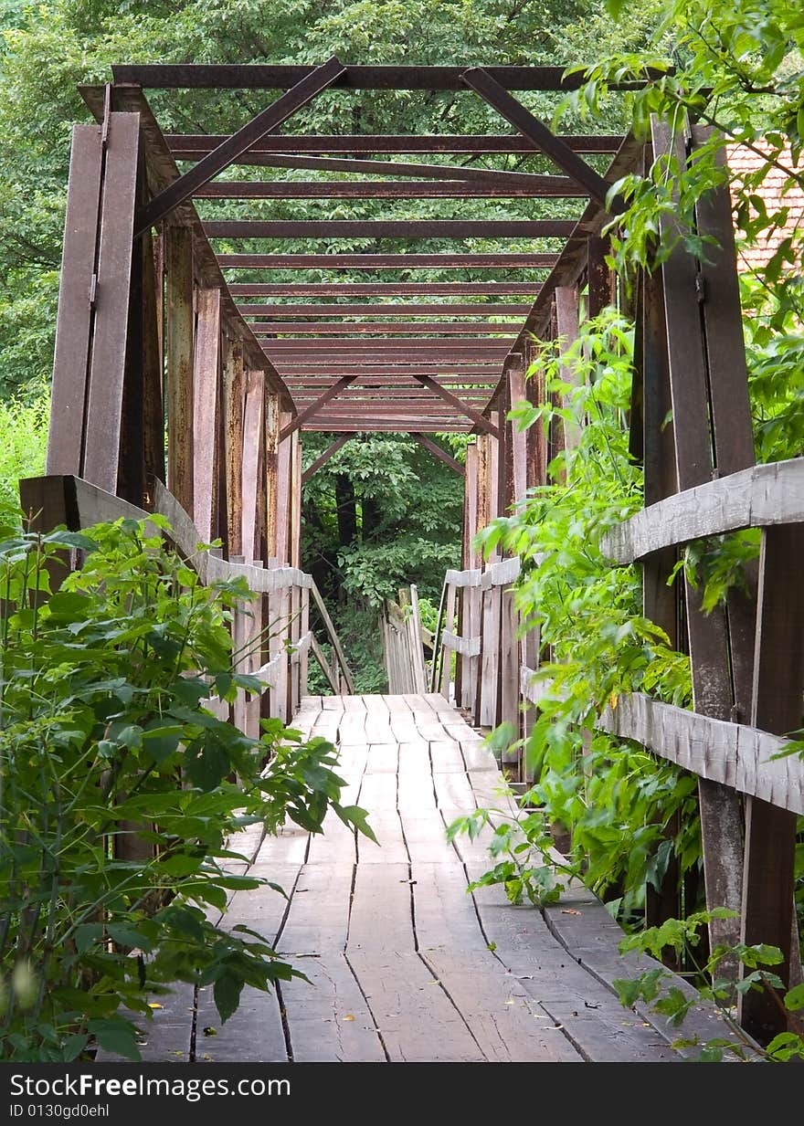 The old bridge through the river in Russia