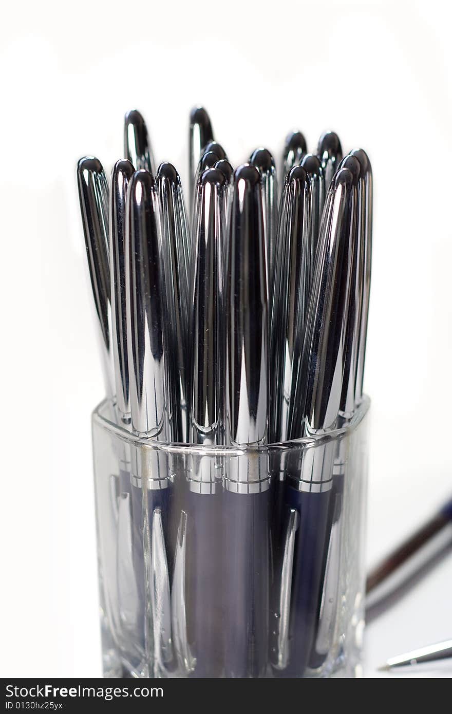 Glass glass with beautiful metallic pens. Glass glass with beautiful metallic pens