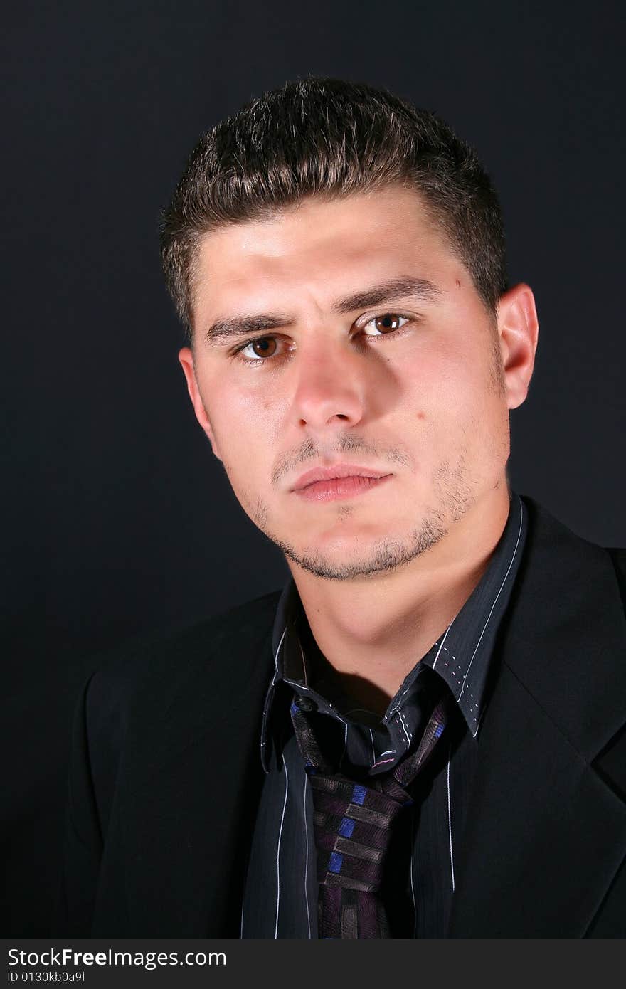 Male model in studio against black background