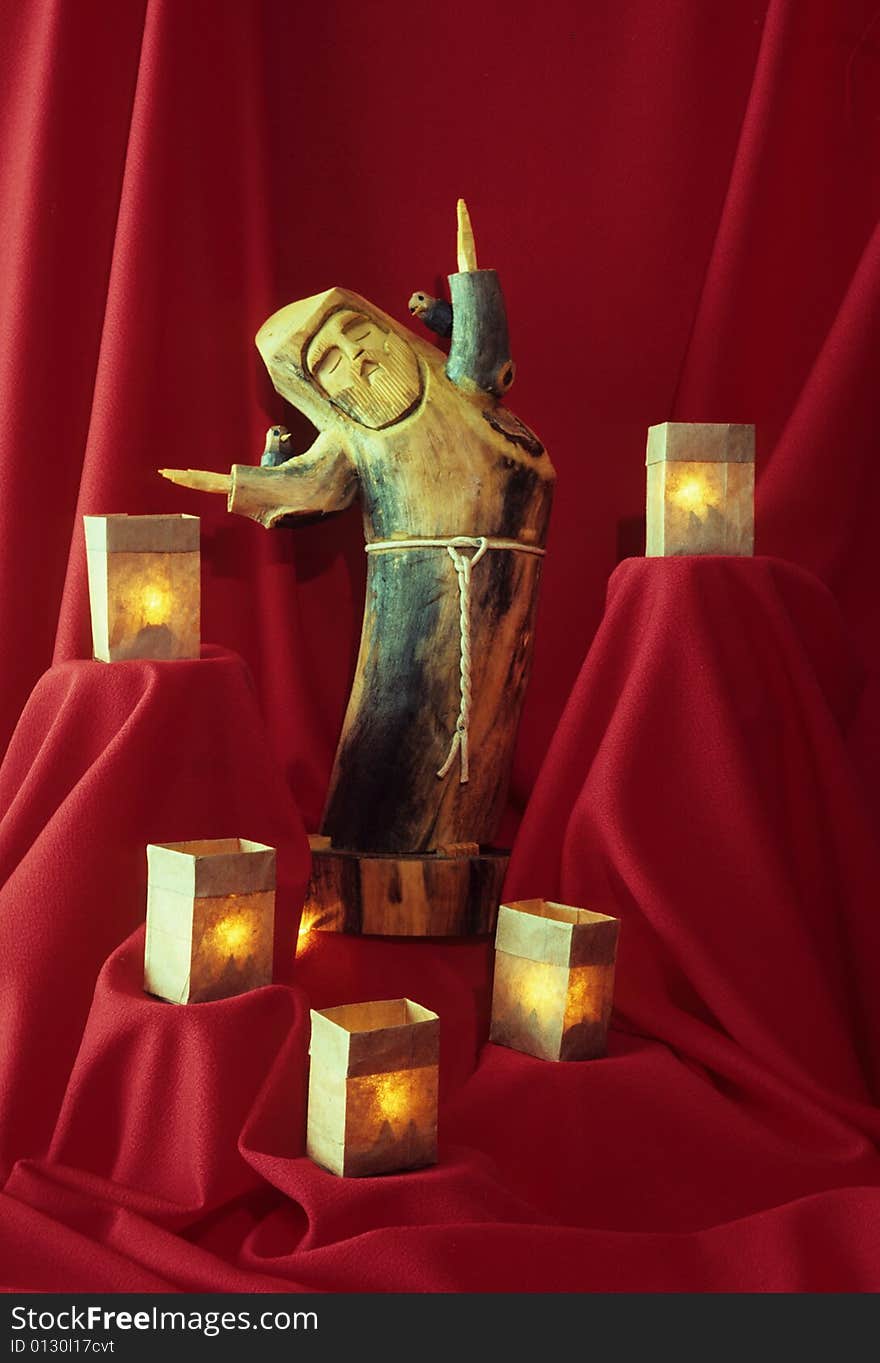 A figure of a priest adorned with candles. A figure of a priest adorned with candles