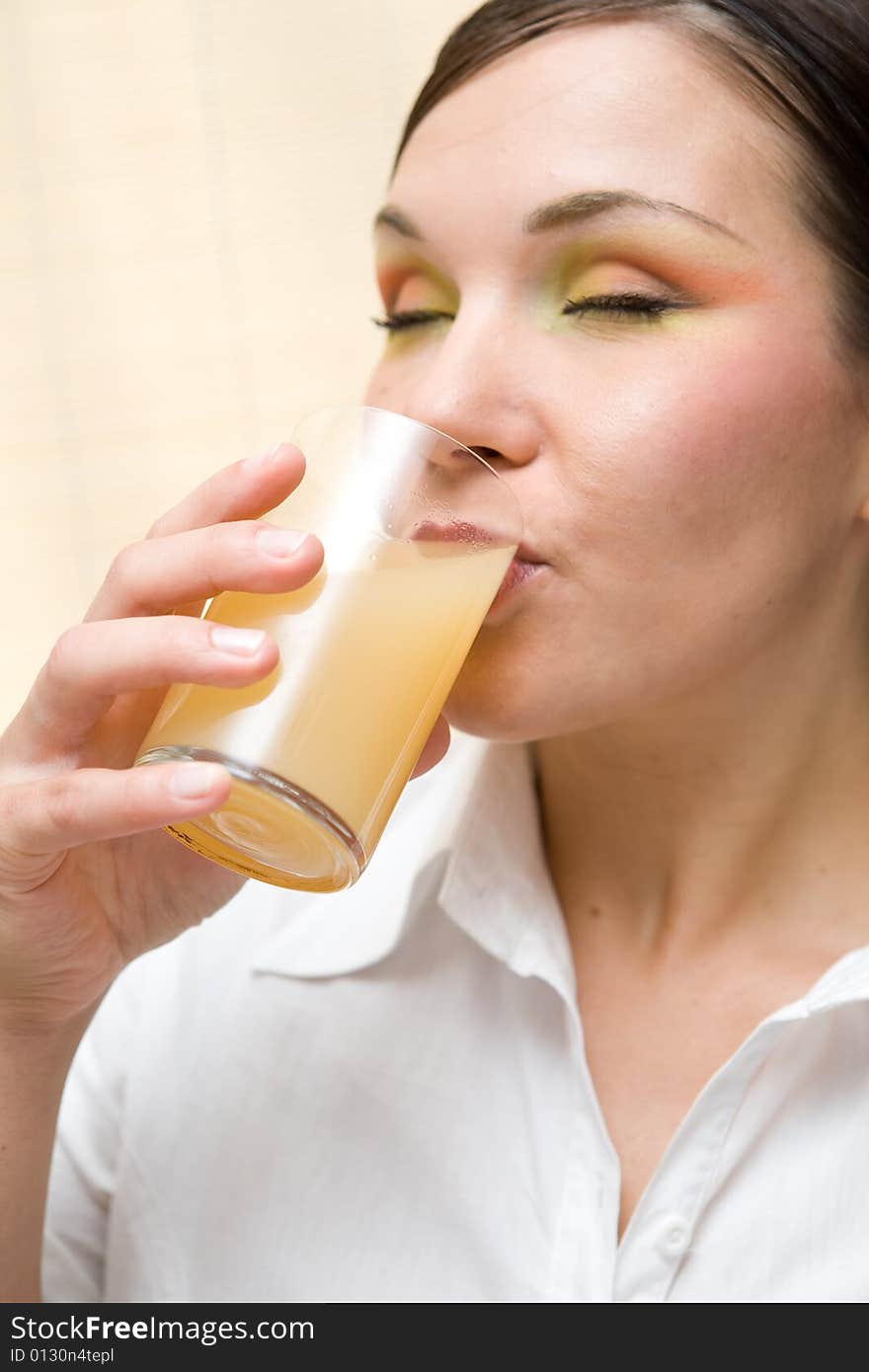 Attractive brunette woman drinking orange juice. Attractive brunette woman drinking orange juice