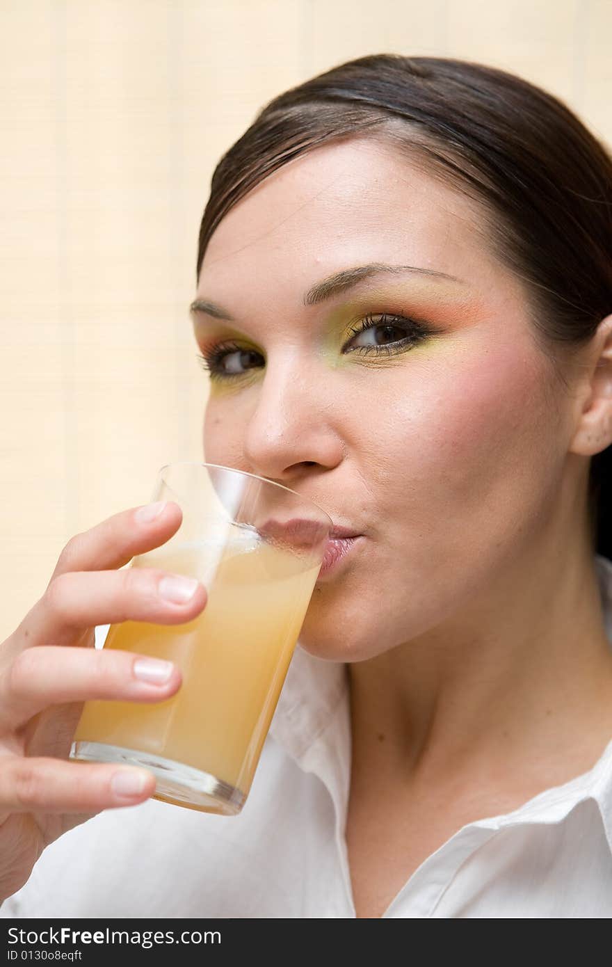 Attractive brunette woman drinking orange juice. Attractive brunette woman drinking orange juice