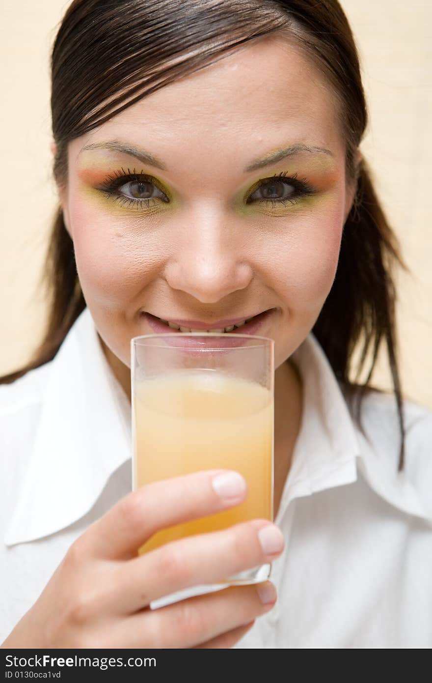 Attractive brunette woman drinking orange juice. Attractive brunette woman drinking orange juice