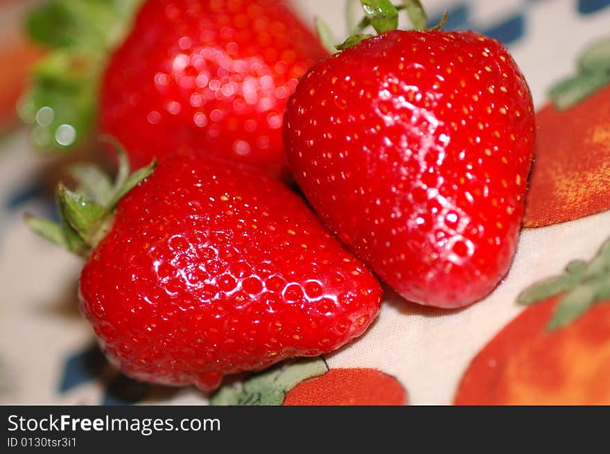 Red strawberries against floreal background. Red strawberries against floreal background