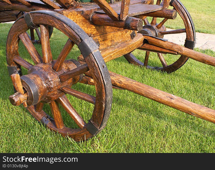 The old wooden cart on the field. The old wooden cart on the field