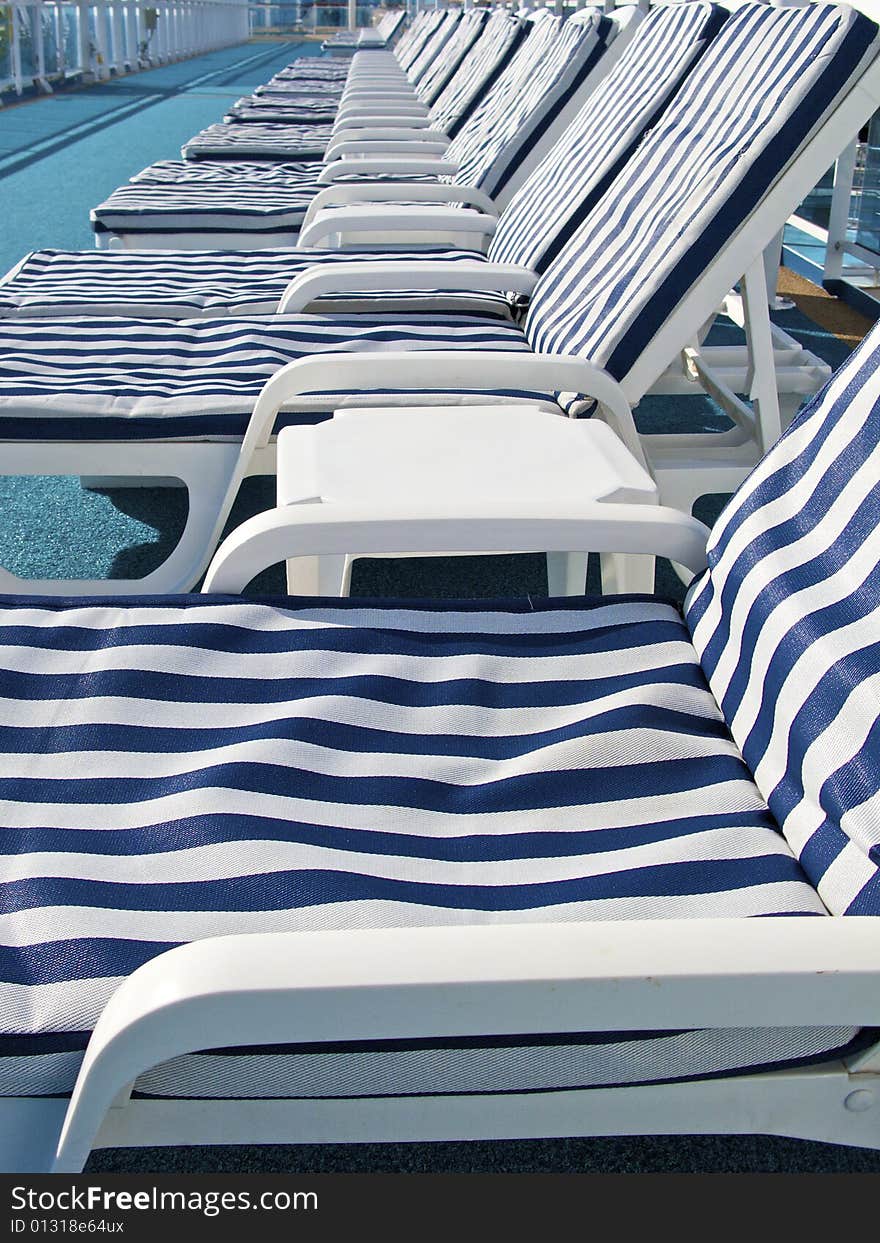 Blue-striped lounge chairs on deck