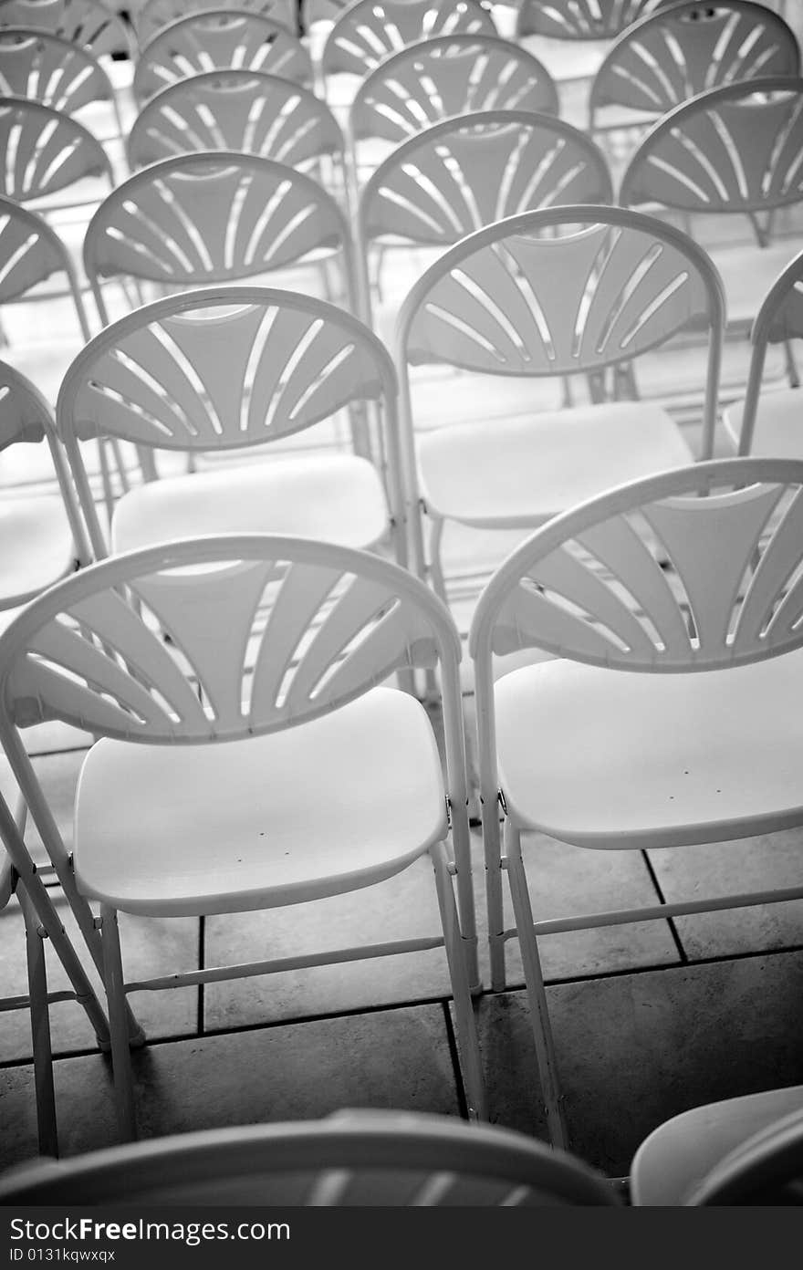 A black and white image of rows of chairs. A black and white image of rows of chairs