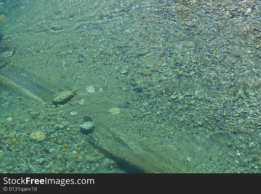 Pebbles in a green river. Pebbles in a green river