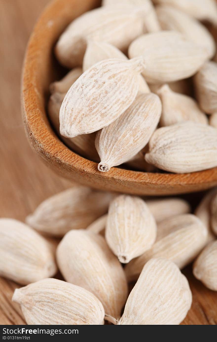 White cardamom in wooden spoon