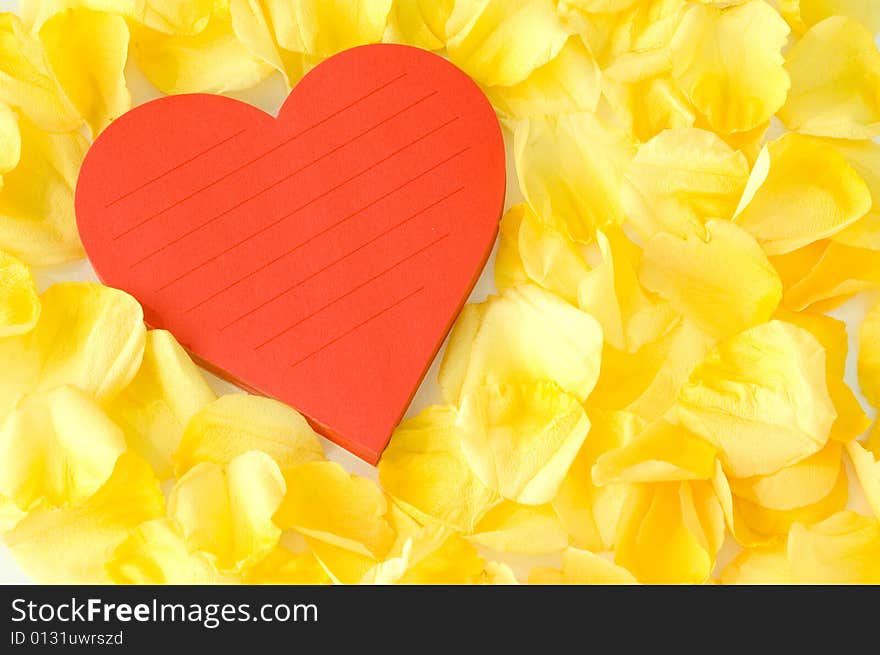 Love note in heart shaped pad surrounded by beautiful petals. Love note in heart shaped pad surrounded by beautiful petals