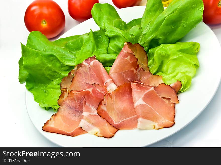 Many Smoked Slices Of Ham With Salad