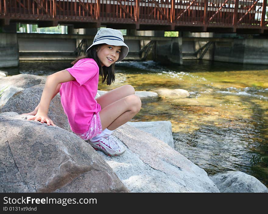 Little girl playing on rocks