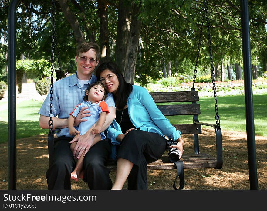 Family of three on swing seat