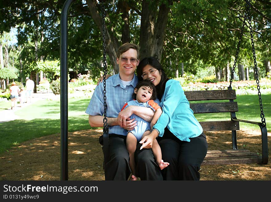 Family of three on swing seat