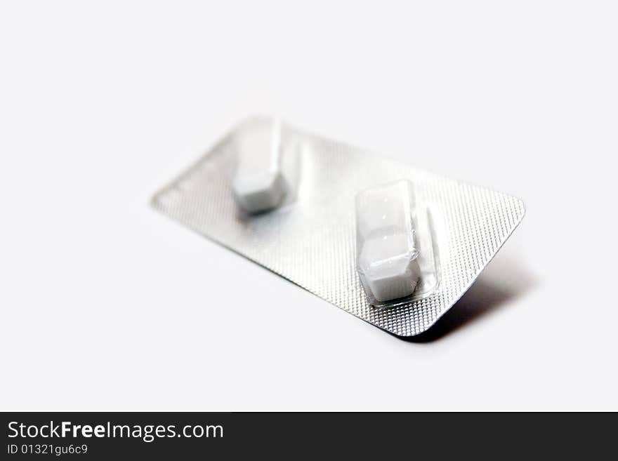 A pair of pills isolated over white