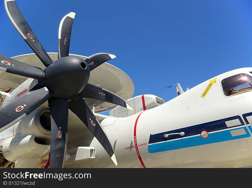 A military sentry plane with an eight blade propeller and a dome on top.