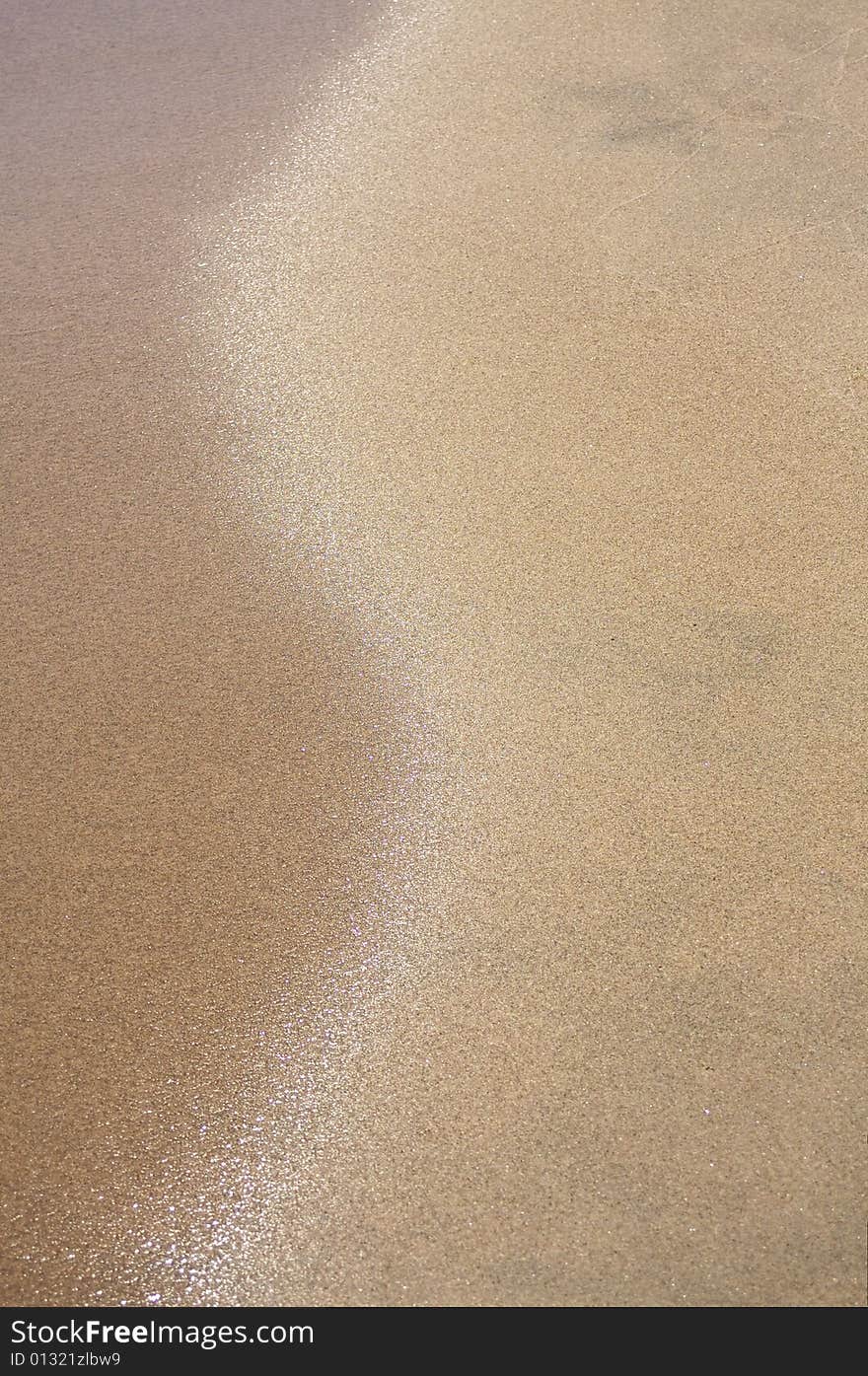 Abstract image of a wave receeding from a sandy beach. Abstract image of a wave receeding from a sandy beach