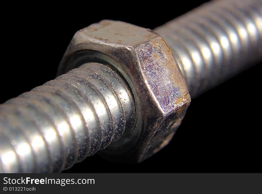 Close up of a nut screwed onto a bolt. Close up of a nut screwed onto a bolt.