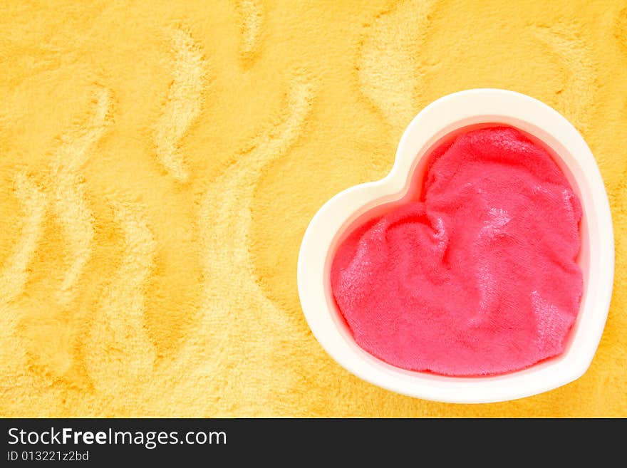 A colorful photograph of a heart shaped object on a yellow background. A colorful photograph of a heart shaped object on a yellow background.