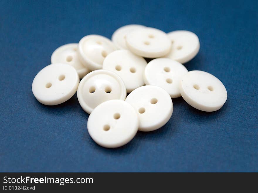 Isolated white buttons on blue background