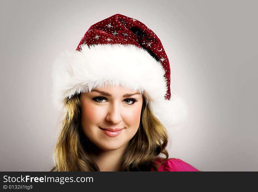 Winter portrait of a beautiful young smiling woman with a christmas cap. Winter portrait of a beautiful young smiling woman with a christmas cap