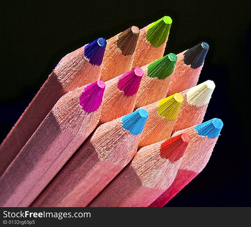 Multicolor pencils on black background