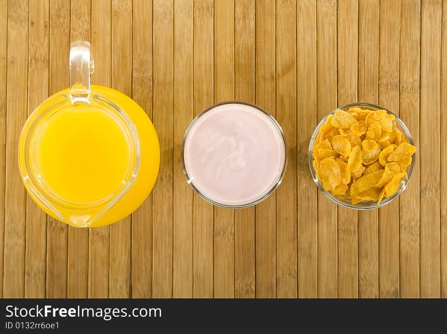 Corn flakes,yoghurt and orange juice. Corn flakes,yoghurt and orange juice