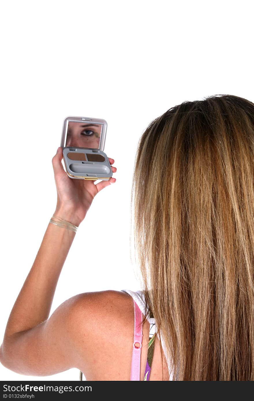 Teen looking into makeup compact