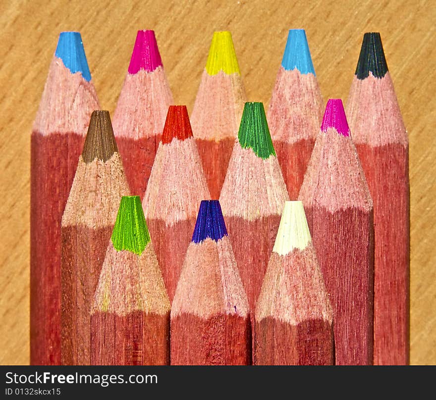 Multicolor pencils on wooden background. Multicolor pencils on wooden background