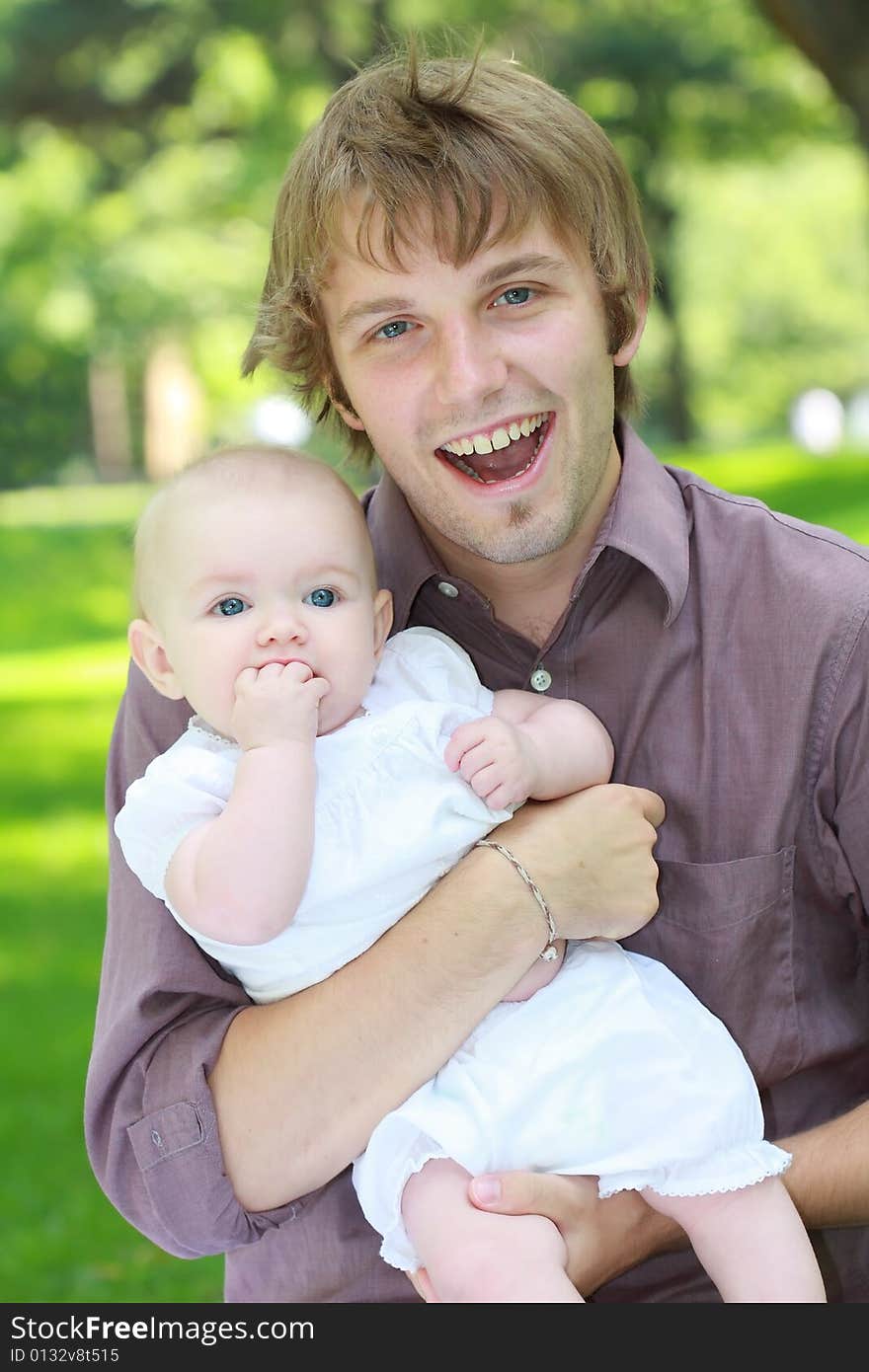 A family shot of Americans outdoor at a park showing happiness together. A family shot of Americans outdoor at a park showing happiness together