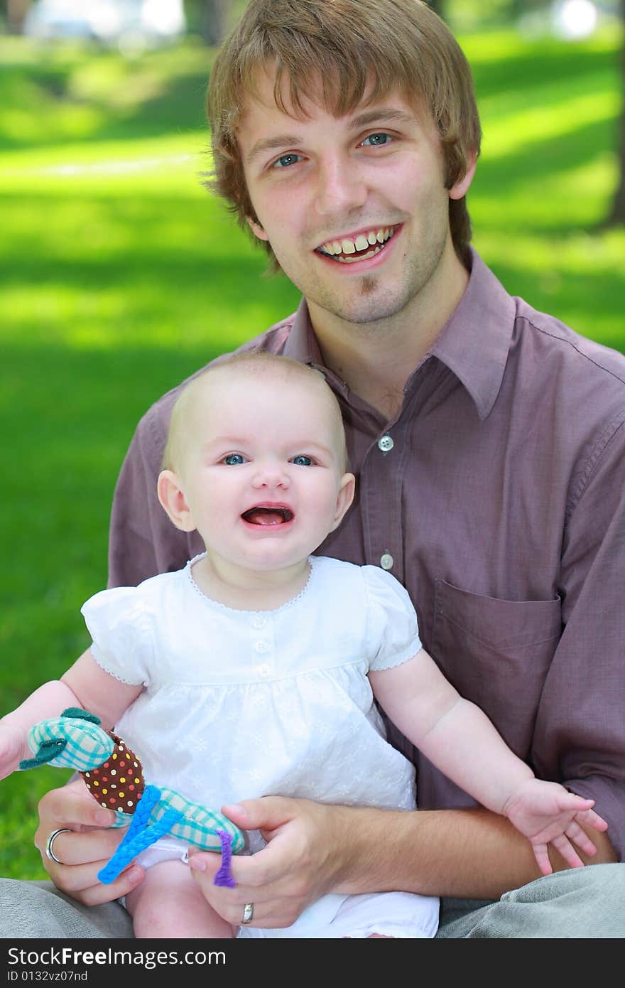 A family shot of Americans outdoor at a park showing hapiness together. A family shot of Americans outdoor at a park showing hapiness together