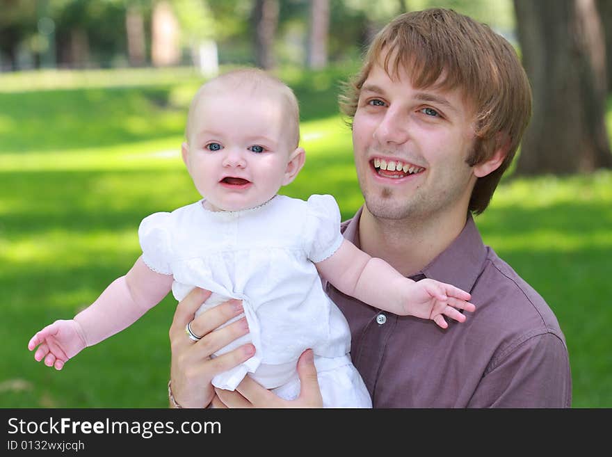 A family shot of Americans outdoor at a park showing happiness together. A family shot of Americans outdoor at a park showing happiness together