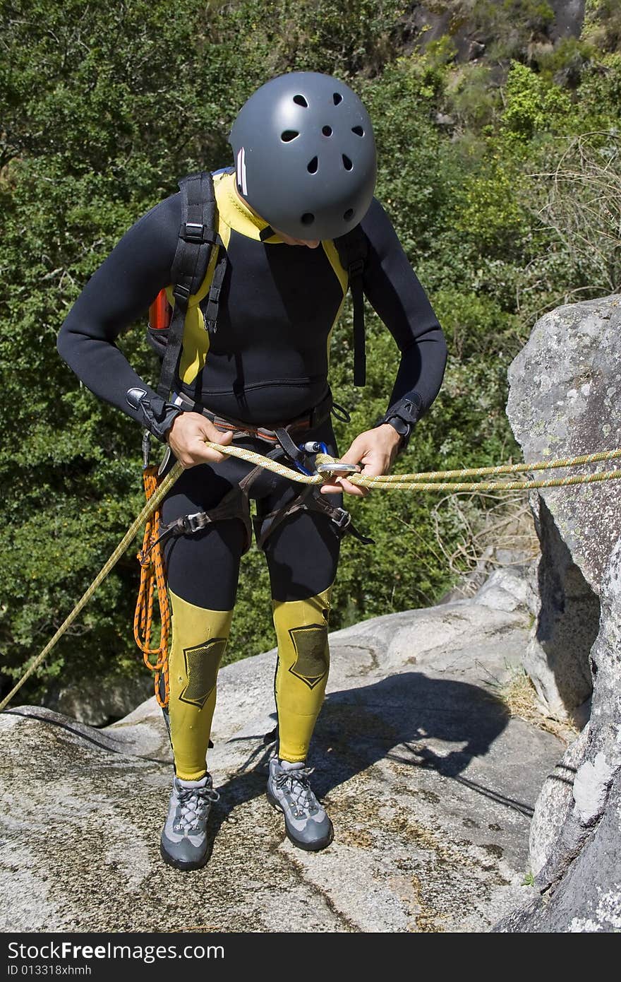 Men prepering for descending waterfall in rappel