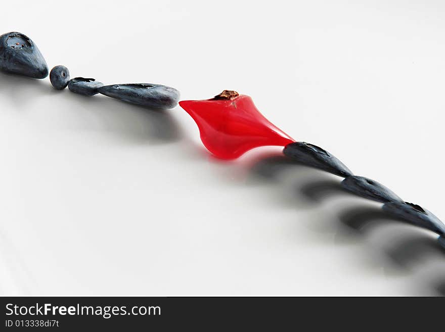 Black and red object on a grey background. Black and red object on a grey background