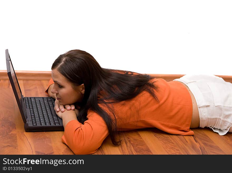 Casual woman lying on floor with laptop. Casual woman lying on floor with laptop