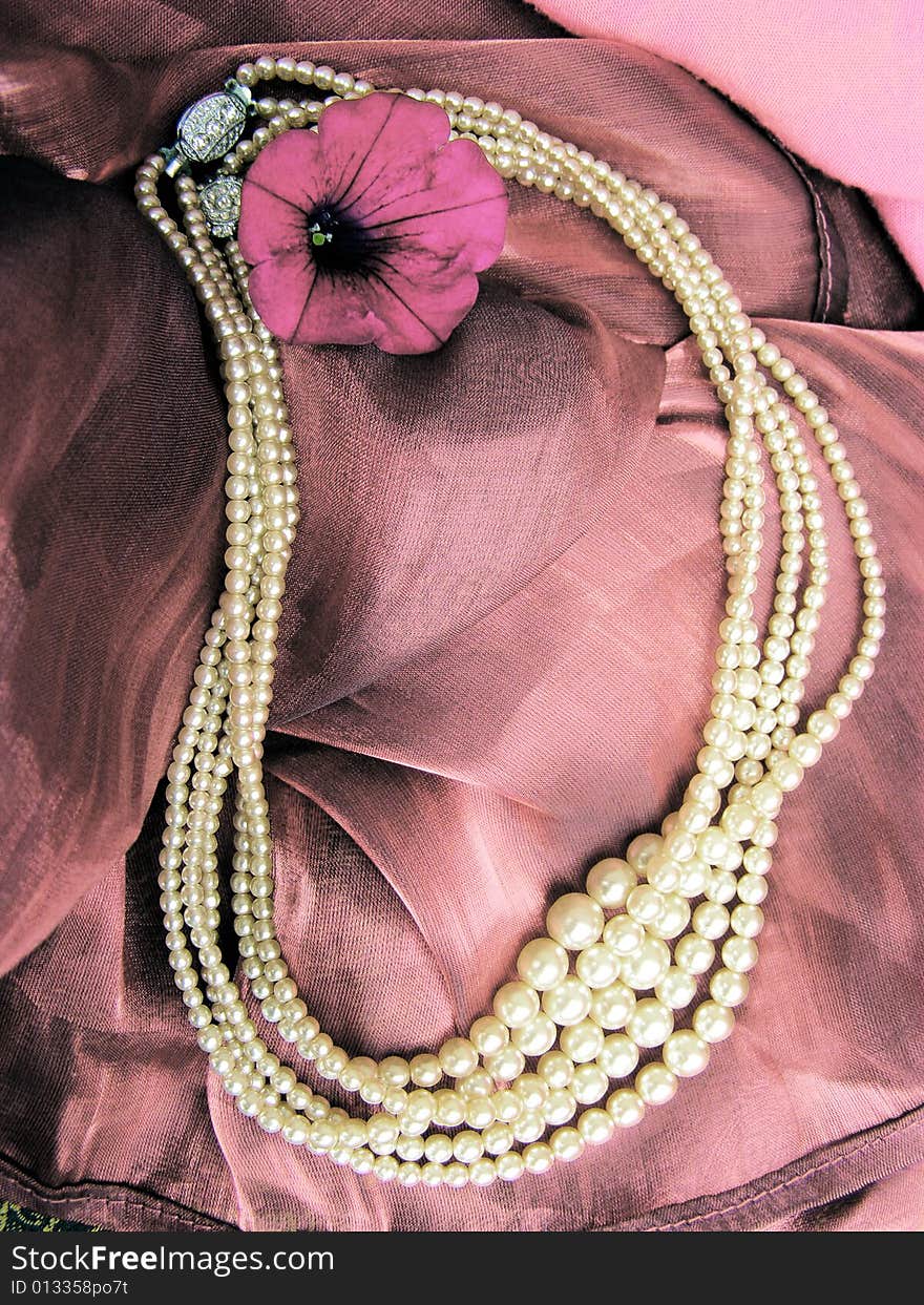 Necklace from white ocean pearls, pink textile and magenta flower. Necklace from white ocean pearls, pink textile and magenta flower.