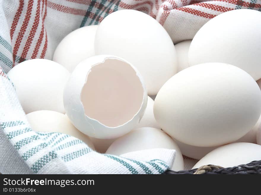 Eggs and an egg shell on kitchen towel. Eggs and an egg shell on kitchen towel